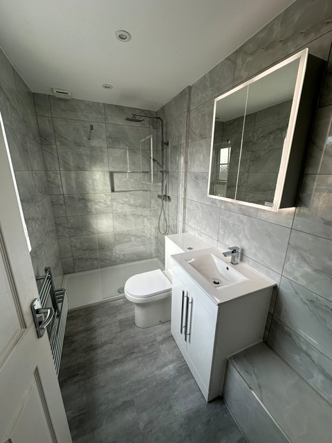 Compact shower room refit, marble-effect tiles